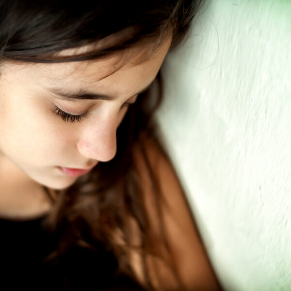 Sad teenage girl lying down
